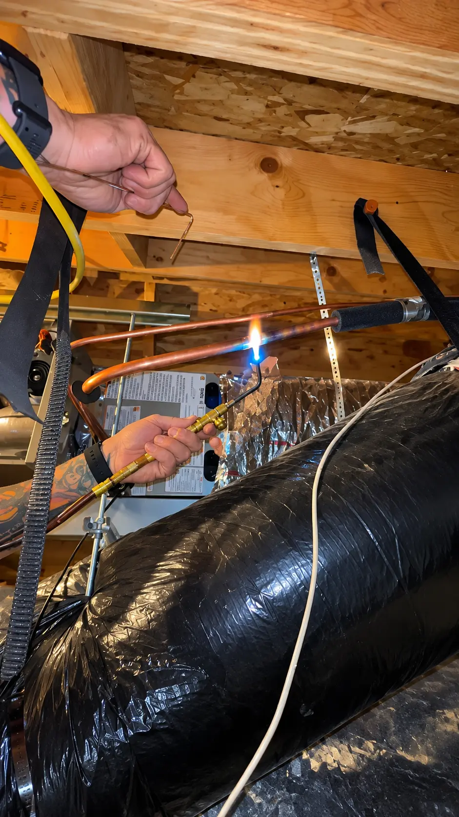 Element HVAC technician brazing copper refrigerant lines in Flagstaff
