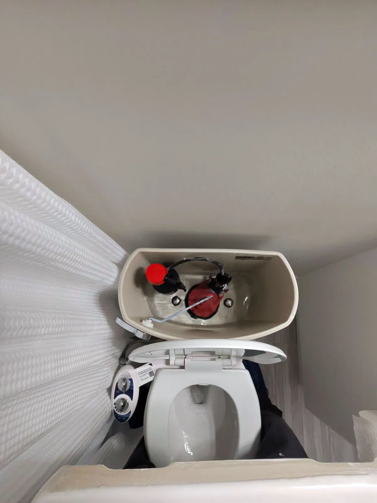 Toilet tank opened for a leak repair in a Flagstaff home